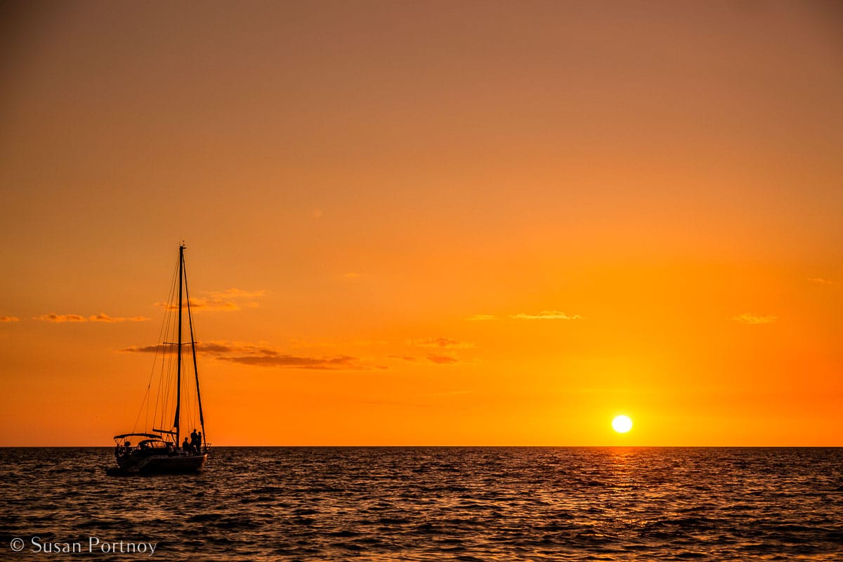 Stunning Silhouette Photos Guaranteed to Inspire Your Travels-A sailboat anchored in the water off Captiva Island in Florida at Sunset.