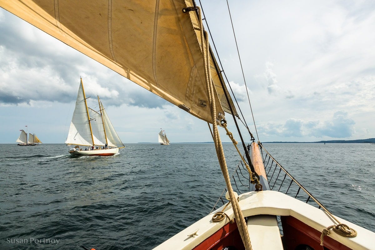 A breathtaking view of Penobscot Bay from the bow of a sailboat with other sailboats in the background