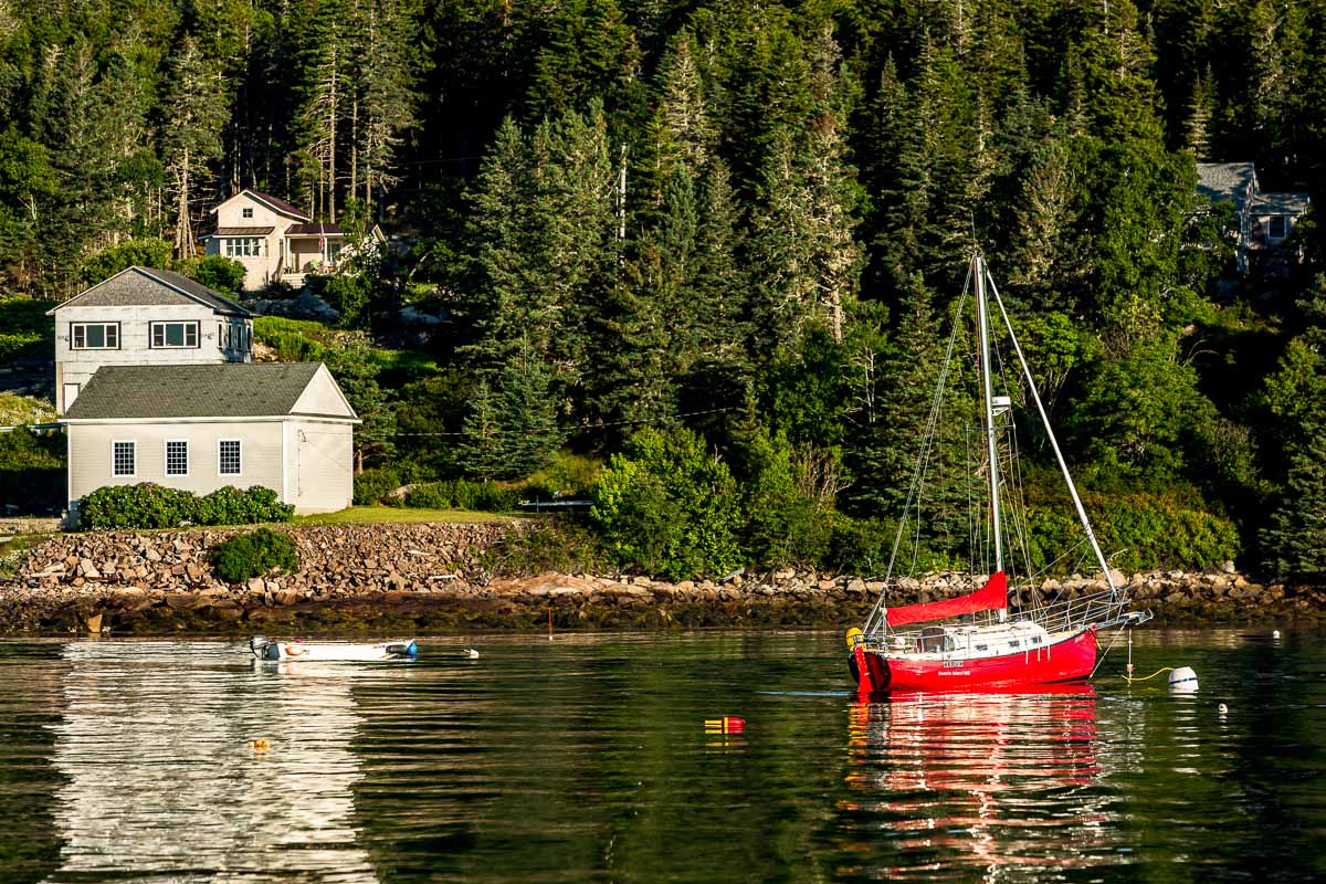 Red sailboat on the water in Maine